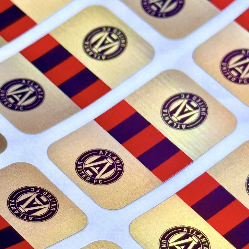 Sheet of custom gold Mag Seals with a round crest and red and black stripes